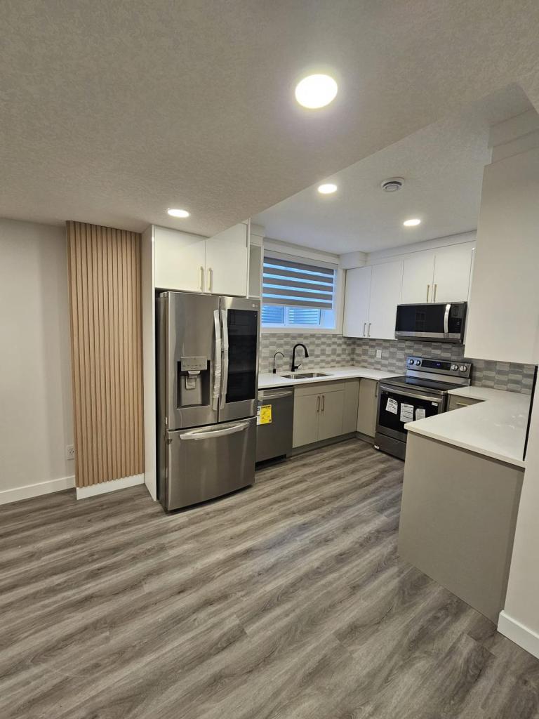 Custom built-in basement cabinetry and shelving in warm wood tones